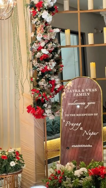 Wooden reception welcome sign with roses